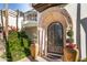 Ornate iron door and stone archway create an elegant entry at 6340 E Huntress Dr, Paradise Valley, AZ 85253