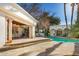 Elegant pool area with covered patio, stone decking, and lush landscaping at 6340 E Huntress Dr, Paradise Valley, AZ 85253