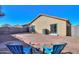 Small backyard with patio and two blue chairs at 639 W Kingman Loop, Casa Grande, AZ 85122