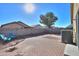 Small backyard with patio and two blue chairs at 639 W Kingman Loop, Casa Grande, AZ 85122