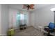 Bedroom featuring wood-look floors, ceiling fan, and window with light curtains at 639 W Kingman Loop, Casa Grande, AZ 85122