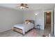 Bedroom with ceiling fan, wood-look floors, and gray bedding at 639 W Kingman Loop, Casa Grande, AZ 85122