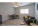 Bright bedroom with wood-look floors, ceiling fan, and comfortable seating at 639 W Kingman Loop, Casa Grande, AZ 85122