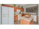 Modern kitchen with island, wood cabinets, and stainless steel appliances at 639 W Kingman Loop, Casa Grande, AZ 85122