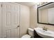 Simple bathroom with a toilet, sink, and framed mirror at 6542 E Ludlow Dr, Scottsdale, AZ 85254