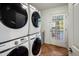 Bright laundry room, featuring stackable washer and dryer, and exterior access at 6542 E Ludlow Dr, Scottsdale, AZ 85254