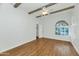 Bedroom with wood flooring, ceiling fan and access to closet at 7238 E Solano Dr, Scottsdale, AZ 85250