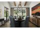 Formal dining room with a large round table, chandelier, and hardwood floors at 7305 E Royal Palm Rd, Scottsdale, AZ 85258