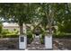 House exterior showcasing a classic design, mature trees, and a brick walkway at 7305 E Royal Palm Rd, Scottsdale, AZ 85258