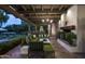 Outdoor patio with seating area, fireplace, and pool view at 7305 E Royal Palm Rd, Scottsdale, AZ 85258