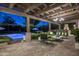 Brick patio with seating area, fire pit, and pool view at 7305 E Royal Palm Rd, Scottsdale, AZ 85258
