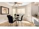 Inviting breakfast nook featuring bright lighting, a charming glass table, and plush, black chairs at 750 E Rosemonte Dr, Phoenix, AZ 85024