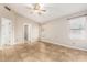 Spacious main bedroom with tile floors, a ceiling fan, natural light, and ensuite bathroom access at 750 E Rosemonte Dr, Phoenix, AZ 85024