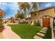 Gathering-friendly backyard with lush artificial grass, a play structure, and a storage shed at 7709 S 72Nd Dl, Laveen, AZ 85339