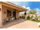 Expansive covered patio with a ceiling fan, dining set, porch swing, and backyard access at 7709 S 72Nd Dl, Laveen, AZ 85339