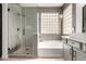 Primary bathroom featuring a glass shower, soaking tub, granite counters, and a sink at 7709 S 72Nd Dl, Laveen, AZ 85339