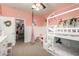 Cozy room with white trim, pink walls, a bunk bed and a closet at 7709 S 72Nd Dl, Laveen, AZ 85339