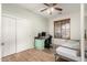 Cozy home office/bedroom features a practical desk space, a comfortable daybed, and wood floors at 7709 S 72Nd Dl, Laveen, AZ 85339