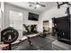 Exercise room with mirror wall and ample equipment and a large television screen on the wall at 7709 S 72Nd Dl, Laveen, AZ 85339