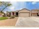 Charming single-story home featuring a two car garage and a well-maintained desert landscape at 7709 S 72Nd Dl, Laveen, AZ 85339