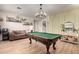 Spacious game room featuring a pool table, decorative shelves and updated lighting, great for entertaining guests at 7709 S 72Nd Dl, Laveen, AZ 85339