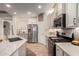 Bright, white kitchen with a stainless steel refrigerator and range at 7709 S 72Nd Dl, Laveen, AZ 85339