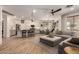 Bright, open-concept living space with wood floors, and modern finishes, seamlessly connecting the kitchen and dining area at 7709 S 72Nd Dl, Laveen, AZ 85339