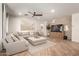 A sun-drenched living room with neutral tones, a cozy sectional sofa, and a stylish ottoman create a relaxing ambiance at 7709 S 72Nd Dl, Laveen, AZ 85339