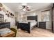 Beautiful main bedroom with a dark wood bed frame, neutral walls and flooring, offering style and comfort at 7709 S 72Nd Dl, Laveen, AZ 85339