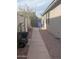 Side yard with walkway, gate, and storage area at 7709 S 72Nd Dl, Laveen, AZ 85339