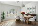 Light and airy dining room featuring a wood table and gray chairs at 7834 E North Ln, Scottsdale, AZ 85258