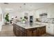 Open kitchen with large island, hardwood floors & living room view at 7834 E North Ln, Scottsdale, AZ 85258