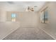 Spacious carpeted bedroom with ceiling fan and window at 832 E Stottler Dr, Gilbert, AZ 85296