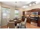 Kitchen with dark brown cabinets, granite countertops, and a round dining table at 832 E Stottler Dr, Gilbert, AZ 85296