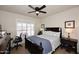 Bright bedroom with a comfortable bed, ceiling fan, and built-in workspace at 9711 E Mountain View Rd # 1545, Scottsdale, AZ 85258