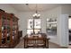 Bright dining area with a wooden table, chairs, and built-in hutch at 9711 E Mountain View Rd # 1545, Scottsdale, AZ 85258