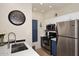 Modern kitchen with stainless steel appliances and blue cabinetry at 9711 E Mountain View Rd # 1545, Scottsdale, AZ 85258