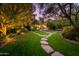 Expansive backyard featuring manicured lawn and stone pathway to the home at 5747 E Mockingbird Ln, Paradise Valley, AZ 85253