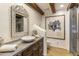 This bathroom features a carved wood mirror frame, exposed beam ceilings and natural elements at 5747 E Mockingbird Ln, Paradise Valley, AZ 85253