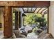 Scenic view from inside the house looking out to a tranquil courtyard with a pond and lush plants at 5747 E Mockingbird Ln, Paradise Valley, AZ 85253