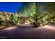 Circular brick driveway leading to the home, framed by lush landscaping and mature trees at 5747 E Mockingbird Ln, Paradise Valley, AZ 85253