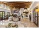 This living room features exposed beam ceilings, spiral staircase and a stone fireplace at Xxxx E Mockingbird Ln, Paradise Valley, AZ 85253