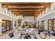 Expansive living room boasts a beamed ceiling, neutral walls and flooring, and plenty of natural light at 5747 E Mockingbird Ln, Paradise Valley, AZ 85253