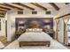 Luxurious main bedroom with wooden beams, decorative wall and ample natural light at 5747 E Mockingbird Ln, Paradise Valley, AZ 85253