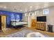 Cozy main bedroom with a blue accent wall, hardwood floors, and bright natural light at 5747 E Mockingbird Ln, Paradise Valley, AZ 85253