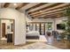 Bright main bedroom boasts wooden beams, fireplace views, and a cozy seating area at 5747 E Mockingbird Ln, Paradise Valley, AZ 85253