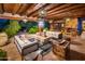 Inviting outdoor space with multiple seating areas, stone fireplace, and decorative lighting at 5747 E Mockingbird Ln, Paradise Valley, AZ 85253