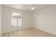 Spacious bedroom with wood-look floors and arched window at 10610 S 48Th St # 2089, Phoenix, AZ 85044