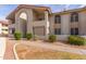 Condo building exterior with landscaping and walkway at 10610 S 48Th St # 2089, Phoenix, AZ 85044
