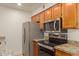 Kitchen features granite counters, wood cabinets and stainless steel appliances at 10610 S 48Th St # 2089, Phoenix, AZ 85044